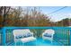 A cozy blue deck with outdoor seating and a wooded view at 318 Lake Montonia Rd, Kings Mountain, NC 28086