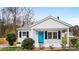 Charming home featuring a blue front door, white painted brick, and a cozy front porch at 318 Lake Montonia Rd, Kings Mountain, NC 28086