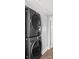 Modern, stacked LG washer and dryer set in a laundry area with light gray walls and white trim at 318 Lake Montonia Rd, Kings Mountain, NC 28086