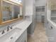 Bathroom featuring a mirror and a walk-in closet with lots of shelves at 3489 Chagall Ct, Charlotte, NC 28205