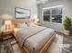 Cozy bedroom featuring a large window, ceiling fan, and neutral decor at 3489 Chagall Ct, Charlotte, NC 28205