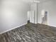 Bright bedroom with neutral paint, hardwood floors, and views of kitchen and hallways at 3489 Chagall Ct, Charlotte, NC 28205
