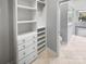 Well-organized walk-in closet with built-in shelves and drawers, with view to the bathroom at 3489 Chagall Ct, Charlotte, NC 28205