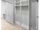 Spacious walk-in closet with custom shelving, drawers, and view to bright bathroom at 3489 Chagall Ct, Charlotte, NC 28205