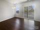 A vacant living room with sliding glass doors at 3489 Chagall Ct, Charlotte, NC 28205
