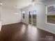 Bright living room with hardwood floors, a ceiling fan, and large sliding glass doors at 3489 Chagall Ct, Charlotte, NC 28205