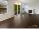 Bright living room featuring hardwood floors, a fireplace, and a door leading to a balcony with outdoor views at 3489 Chagall Ct, Charlotte, NC 28205