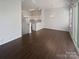 Open floor plan: Living room flows to kitchen with bar top, hardwood floors, and lots of natural light at 3489 Chagall Ct, Charlotte, NC 28205