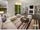 Bright living room featuring fireplace, built-in bookshelves, and a balcony at 3489 Chagall Ct, Charlotte, NC 28205