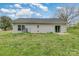 Spacious backyard with a sliding glass door entry to the home at 413 E Henderson Es St, East Spencer, NC 28144