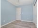 This bedroom has light-blue walls, light-grey laminate flooring and a white door and closet at 413 E Henderson Es St, East Spencer, NC 28144
