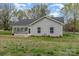 Charming single-story home featuring a sunroom addition and a well-maintained front yard at 413 E Henderson Es St, East Spencer, NC 28144