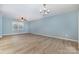 Light-filled living room boasts new flooring and ample space for relaxation and entertaining at 413 E Henderson Es St, East Spencer, NC 28144