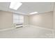Finished basement space featuring tile flooring and a large window at 431 Sullivan Rd, Statesville, NC 28677