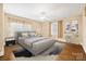 This staged bedroom features a king bed, ceiling fan, hardwood floors, and great natural light at 431 Sullivan Rd, Statesville, NC 28677