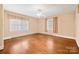 Sun-filled bedroom featuring hardwood floors and large windows at 431 Sullivan Rd, Statesville, NC 28677