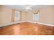 Sunlit bedroom with hardwood floors and neutral walls features updated windows at 431 Sullivan Rd, Statesville, NC 28677