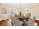 Elegant dining room features a round table, chandelier, and sliding glass doors to the deck at 431 Sullivan Rd, Statesville, NC 28677