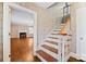 Inviting entryway with hardwood stairs and patterned wallpaper, creating a stylish and classic first impression at 431 Sullivan Rd, Statesville, NC 28677