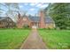 Classic brick home with a well-manicured lawn and mature trees, creating a welcoming exterior at 431 Sullivan Rd, Statesville, NC 28677