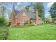 Charming two-story brick home with a landscaped lawn, mature trees, and inviting curb appeal at 431 Sullivan Rd, Statesville, NC 28677