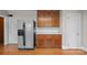 Kitchen featuring stainless steel refrigerator, wood cabinets, and white subway tile at 431 Sullivan Rd, Statesville, NC 28677