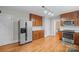 Well-lit kitchen with stainless steel appliances, wood cabinets and tile backsplash at 431 Sullivan Rd, Statesville, NC 28677