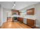 Modern kitchen with wood cabinetry, stainless steel appliances, and eat-in dining area at 431 Sullivan Rd, Statesville, NC 28677