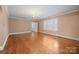 Spacious living room with hardwood floors, a chandelier, and bright windows, perfect for entertaining and relaxation at 431 Sullivan Rd, Statesville, NC 28677