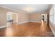 Bright living room with hardwood floors, chandelier, and open layout, seamlessly connecting to the dining area at 431 Sullivan Rd, Statesville, NC 28677