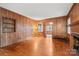 Cozy living room with wood paneling, hardwood floors, and a fireplace, offering a warm and inviting space at 431 Sullivan Rd, Statesville, NC 28677