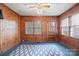 Cozy sunroom with wood paneling, ceiling fan, and ample natural light, creating a relaxing and bright atmosphere at 431 Sullivan Rd, Statesville, NC 28677