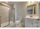 Modern bathroom featuring tile flooring, glass shower, toilet, and classic vanity at 4503 Hunton Dale Nw Rd, Concord, NC 28027