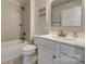 Bright bathroom showcases a tub-shower, white vanity, and tiled flooring at 4503 Hunton Dale Nw Rd, Concord, NC 28027