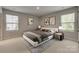 Relaxing bedroom with neutral tones, plush carpet, large windows, and modern decor at 4503 Hunton Dale Nw Rd, Concord, NC 28027