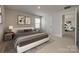 Comfortable bedroom featuring a king-size bed, soft carpet, and an open doorway to the living room at 4503 Hunton Dale Nw Rd, Concord, NC 28027