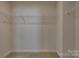Walk-in closet with white wire shelving, ample storage, and neutral carpet at 4503 Hunton Dale Nw Rd, Concord, NC 28027