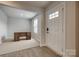 Bright foyer features wood-look floors and a modern front door, leading into an adjacent room with a wooden desk at 4503 Hunton Dale Nw Rd, Concord, NC 28027