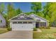 Charming single-story home with a two car garage, stone accents, and manicured lawn at 4503 Hunton Dale Nw Rd, Concord, NC 28027