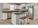 Modern kitchen boasts stainless steel appliances, granite countertops, and a functional island with seating at 4503 Hunton Dale Nw Rd, Concord, NC 28027