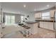 Open-concept living space with an island kitchen and a cozy living area with a modern sofa at 4503 Hunton Dale Nw Rd, Concord, NC 28027