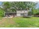 Spacious backyard features a deck with grill, trampoline, and a well-maintained lawn at 511 Plymouth Ave, Salisbury, NC 28144