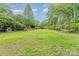 Expansive backyard offering a shed, playground, hammock, and abundant green space for outdoor activities at 511 Plymouth Ave, Salisbury, NC 28144