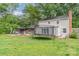 Large backyard with a deck, grill, trampoline, and beautiful greenery creating a serene outdoor space at 511 Plymouth Ave, Salisbury, NC 28144