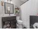 Well-decorated bathroom with a framed mirror, shelves, patterned floors, and a shower at 511 Plymouth Ave, Salisbury, NC 28144