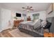 Cozy bedroom featuring a ceiling fan, window, and a bed with stylish black and white checkered accents at 511 Plymouth Ave, Salisbury, NC 28144