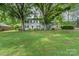 Traditional home with lush greenery and mature trees shading the front yard at 511 Plymouth Ave, Salisbury, NC 28144