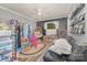 Cozy playroom features a woven chair, shelves, window, and herringbone wallpaper at 511 Plymouth Ave, Salisbury, NC 28144