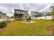 Spacious backyard features a fire pit with colorful chairs and a screened-in porch at 5664 Norwood Ridge Dr, Rock Hill, SC 29732
