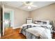 Bedroom with white bedding, hardwood floors, white dresser and natural light at 5664 Norwood Ridge Dr, Rock Hill, SC 29732